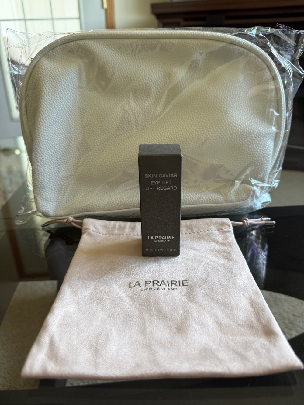 La Prairie eye lift caviar serum with La Prairie cosmetics pouch.